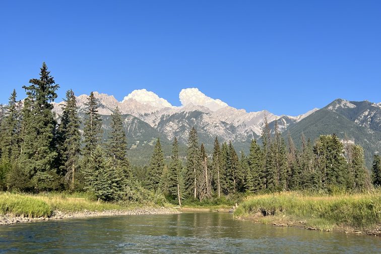 A river running below the mountains of the Columbia Valley in British Columbia